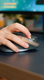 Midsection of man using mobile phone on table