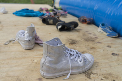 Close-up of shoes on sand