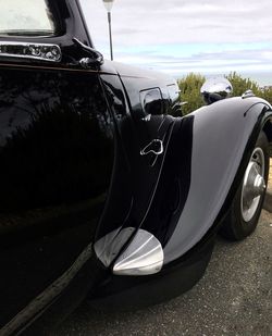 Close-up of car on road against sky