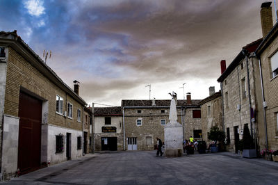 Empty road with buildings in background