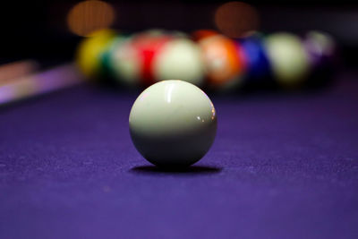 Close-up of multi colored pool balls on table