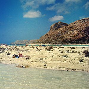 Scenic view of beach against blue sky