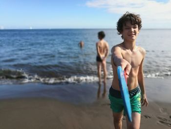 Full length of teenage girl standing on beach