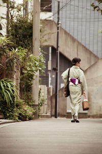 Full length of woman standing by railing