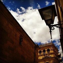 Low angle view of building against cloudy sky
