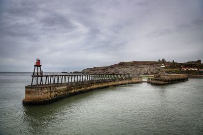 Bridge over sea against sky