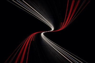 Light trails on road in illuminated tunnel