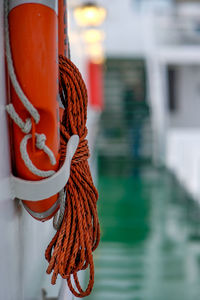 Close-up of rope tied to pole against building