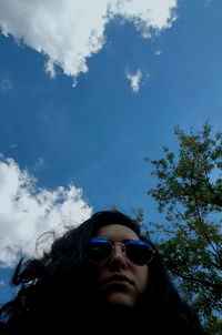 Low angle view of woman standing against clear sky