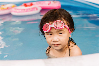 Portrait of cute girl in swimming pool