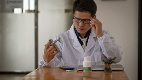 Man wearing eyeglasses on table