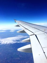 Airplane wing against blue sky