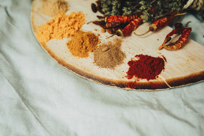 Spices and red chili peppers on table