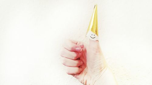 Close-up of hand holding over white background