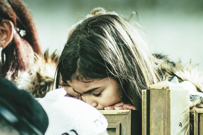 Portrait of woman with girl relaxing outdoors