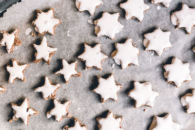 High angle view of dough with star shapes on table