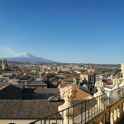 Cityscape against clear blue sky