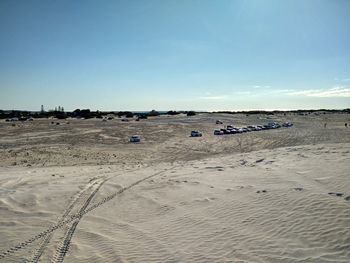 Scenic view of beach against blue sky