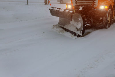 Snow covered road in city