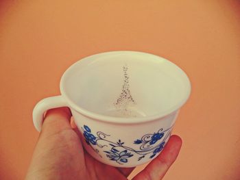 Close-up of hand holding coffee cup