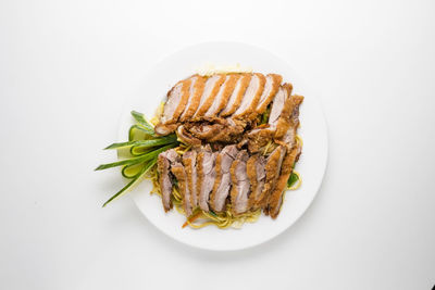 High angle view of food in plate against white background