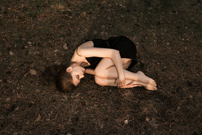 High angle view of woman lying on land