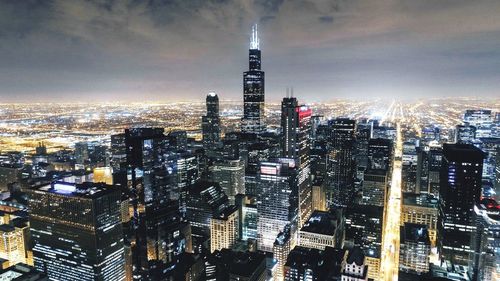 Aerial view of city lit up at night