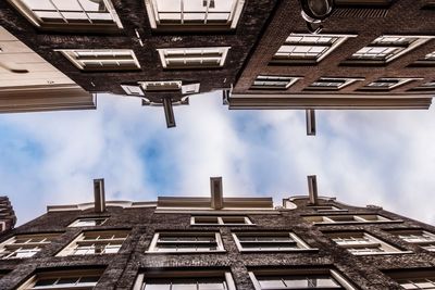 Low angle view of building against cloudy sky