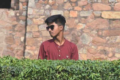 Portrait of young man against wall