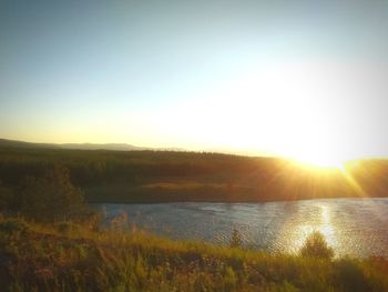 Scenic view of lake against sky during sunset