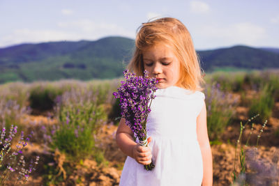 Beautiful woman standing in front of flower