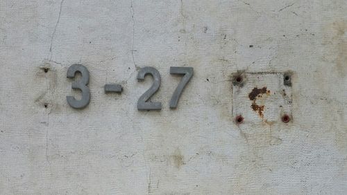 Close-up of text on brick wall
