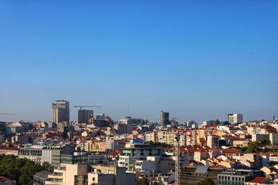 High angle view of townscape against blue sky
