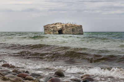 Old german bunker is rinsed out in the sea of the baltic coast