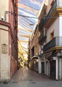 Street amidst buildings against sky