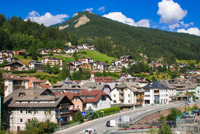 High angle view of townscape by mountain against sky