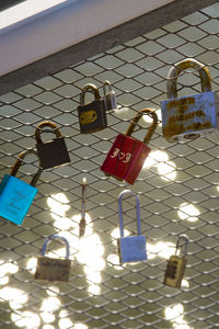 Close-up of padlocks hanging on railing