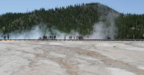 People at yellowstone national park against sky