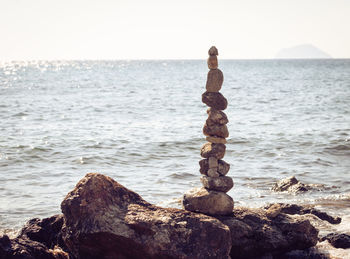 Scenic view of rocks on beach against sky