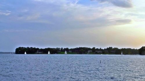 Scenic view of river against cloudy sky