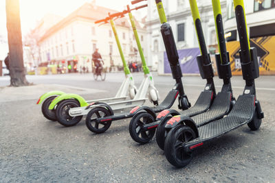 Close-up of push scooters on road