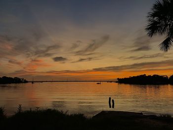 Scenic view of lake against orange sky