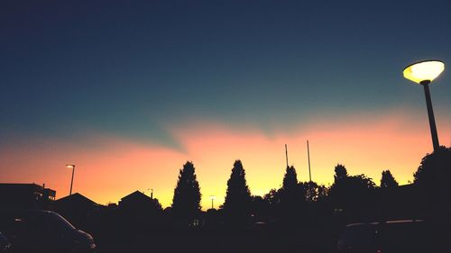 Silhouette trees against clear sky during sunset