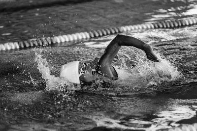 Female swimmer on training in the swimming pool. front crawl swimming style