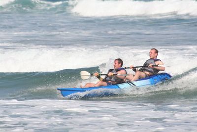 High angle view of men sitting on beach