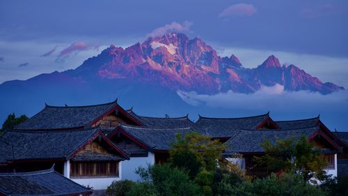 Houses and mountains against sky