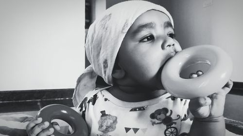 Close-up of baby girl playing at home