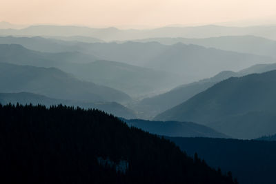 Scenic view of silhouette mountains against sky at sunset