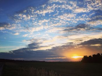 Scenic view of field against sky during sunset