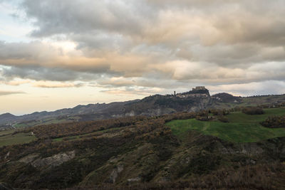 Scenic view of mountains against cloudy sky